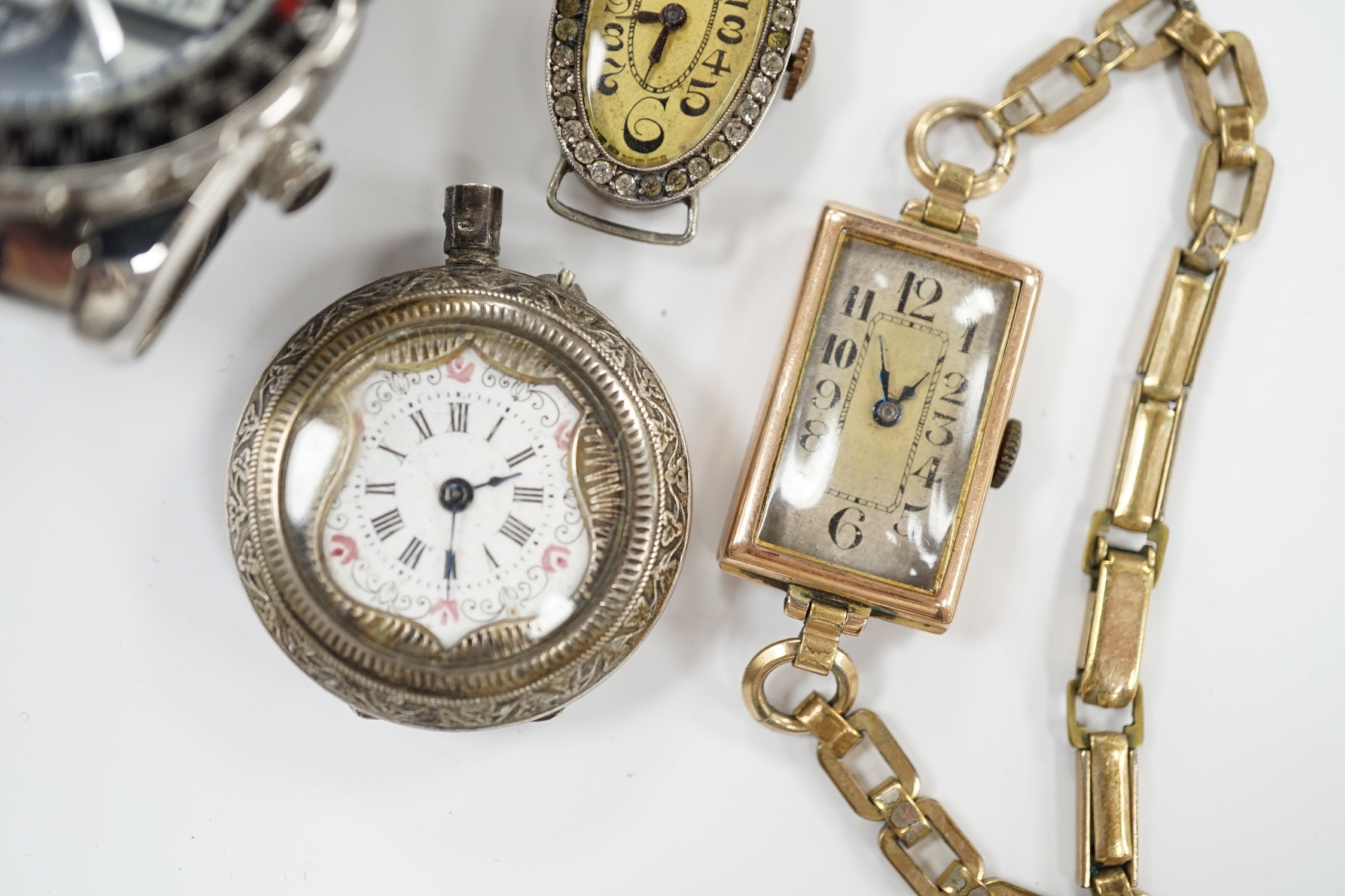 A lady's 1920's 9ct gold rectangular dial manual wind wrist watch, on a rolled gold bracelet, a similar silver and paste set wrist watch (no strap), an 800 standard white metal fob watch, a strap and a later Accurist ana